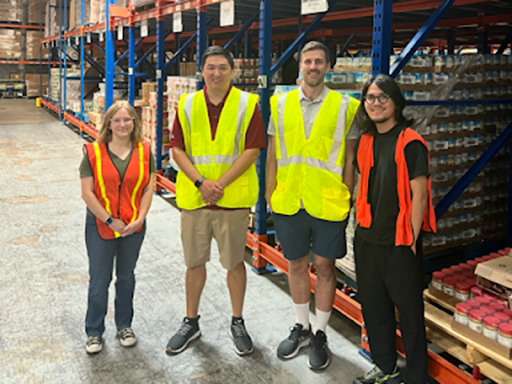 members of the Data Devils lab wearing safety vests inside a warehouse